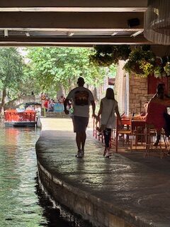 A couple strolling on San Antonio River walk.