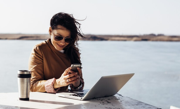 A person doing remote work at the beach.